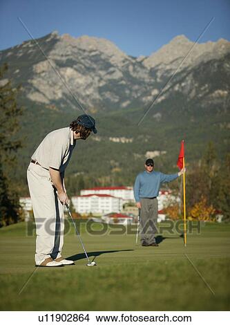 Picture - Making the putt. Fotosearch