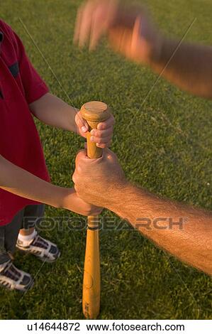 Male and boy's arms with baseball bat View Large Photo Image Stock Image - Male and boy's arms with baseball bat. Fotosearch