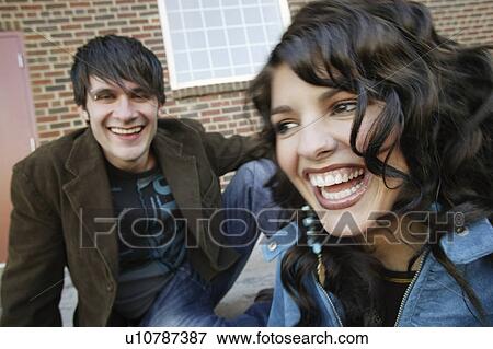 Stock Photo - Man and woman laughing together. Fotosearch