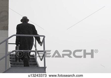 Man climbing outside stairs in cold weather View Large Photo Image Stock Image - Man climbing outside stairs in cold weather. Fotosearch