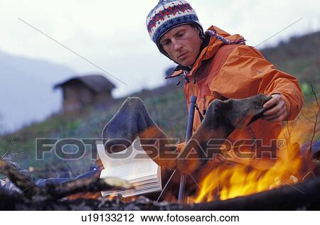 Man drying socks by campfire View Large Photo Image Stock Image - Man drying socks by campfire. Fotosearch