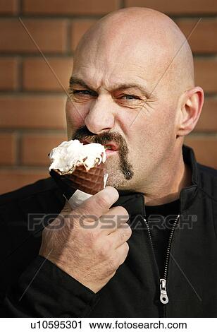 Stock Image - Man eating ice cream. Fotosearch