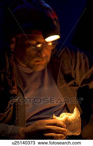 Man eating sandwich in dark with help of headlamp View Large Photo Image Stock Image - Man eating sandwich in dark with help of headlamp. Fotosearch