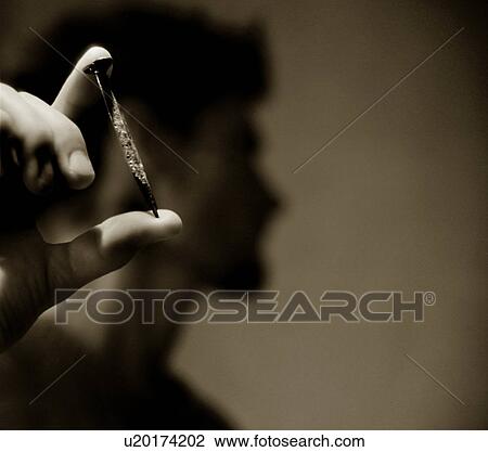 Man holding old nail View Large Photo Image Stock Image - Man holding old nail. Fotosearch