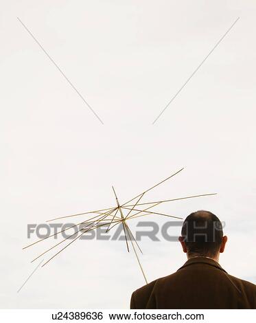 Man holding useless umbrella View Large Photo Image Stock Photograph - Man holding useless umbrella. Fotosearch