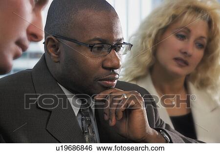 Stock Photograph - Man in a meeting. Fotosearch