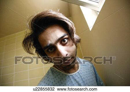 Stock Image - Man in hospital gown. Fotosearch