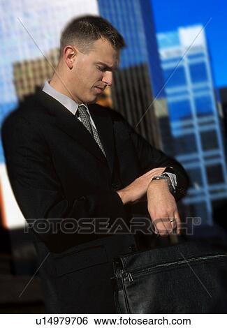 Man looking at watch View Large Photo Image Stock Photograph - Man looking at watch. Fotosearch