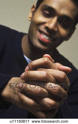 Man looks down at hands View Large Photo Image Stock Photo - Man looks down at hands. Fotosearch