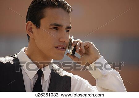 Stock Image - Man on cell phone. Fotosearch