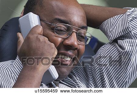 Man on telephone View Large Photo Image Stock Photo - Man on telephone. Fotosearch
