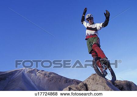 Stock Photo - Man on unicycle. Fotosearch