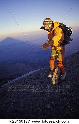 Stock Photo - Man on unicycle. Fotosearch