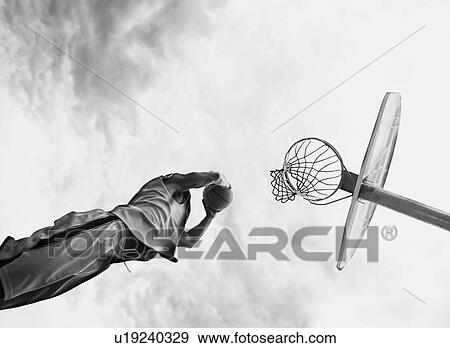 Stock Photo - Man playing basketball. Fotosearch