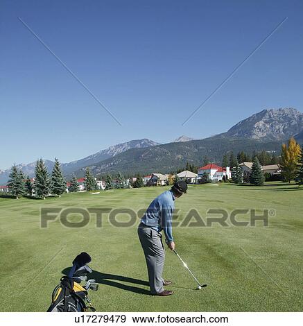 Stock Photo - Man playing golf. Fotosearch