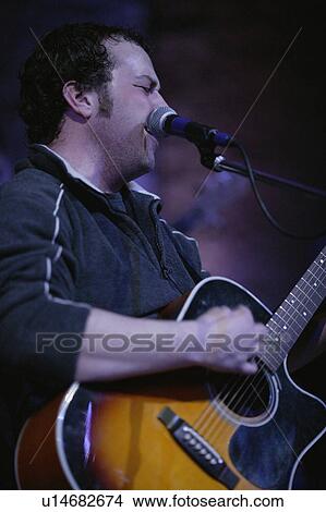 Man playing guitar and singing View Large Photo Image Picture - Man playing guitar and singing. Fotosearch