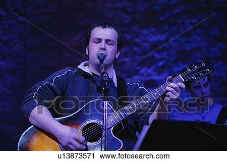 Man playing guitar and singing View Large Photo Image Stock Image - Man playing guitar and singing. Fotosearch
