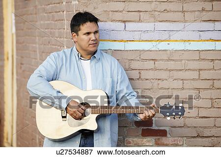 Man plays guitar View Large Photo Image Stock Photo - Man plays guitar. Fotosearch
