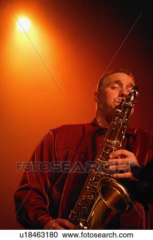 Stock Image - Man plays saxophone. Fotosearch