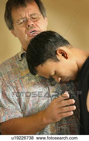 Stock Photo - Man praying with teenager. Fotosearch