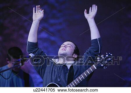 Stock Photography - Man raising hands in worship. Fotosearch