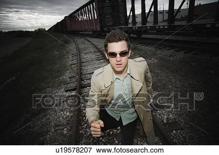 Stock Photo - Man runs alongside a train. Fotosearch