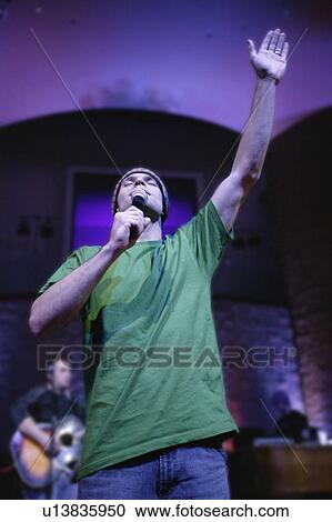 Man singing with microphone View Large Photo Image Stock Image - Man singing with microphone. Fotosearch