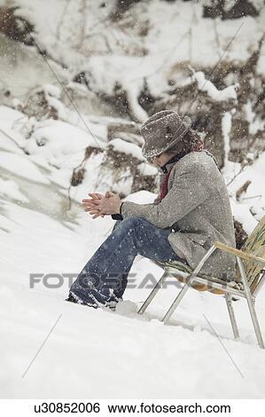 Man sitting in chair in snow View Large Photo Image Stock Photograph - Man sitting in chair in snow. Fotosearch