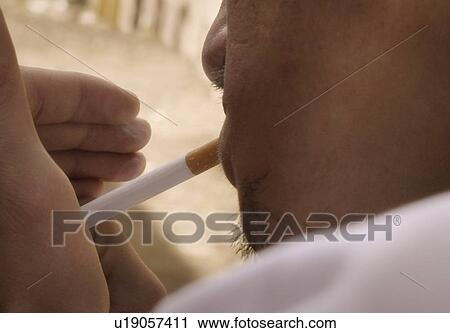 Stock Image - Man smokes a cigarette. Fotosearch