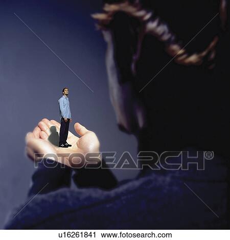 Man standing on hand View Large Photo Image Stock Image - Man standing on hand. Fotosearch