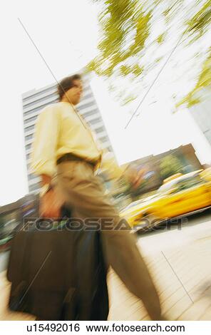 Man walks downtown View Large Photo Image Stock Photograph - Man walks downtown. Fotosearch