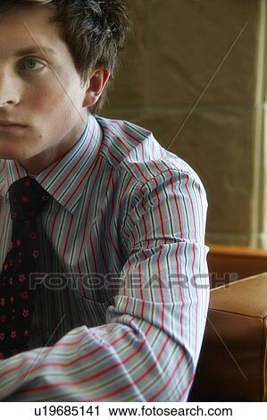 Stock Image - Man wearing a striped shirt. Fotosearch