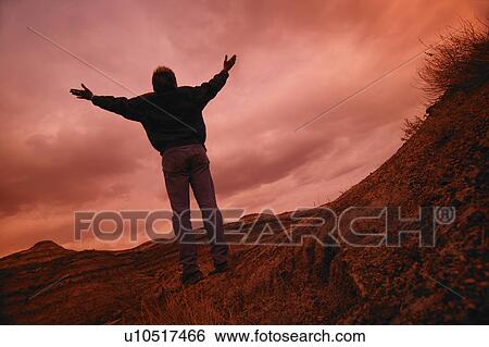 Stock Photograph - Man with arms raised. Fotosearch
