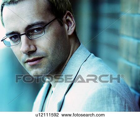 Stock Image - Man with glasses in suit jacket. Fotosearch