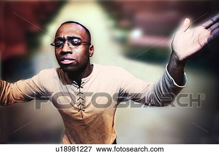 Stock Photo - Man with hands raised in worship. Fotosearch