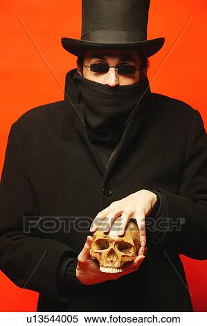 Stock Photography - Man with skull. Fotosearch