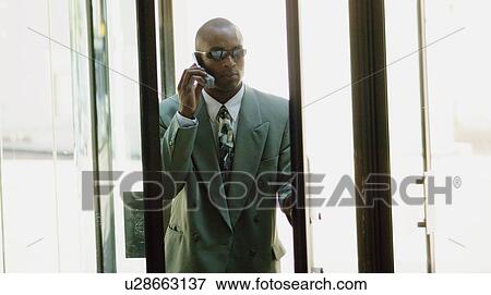 Man with sunglasses and cell phone View Large Photo Image Stock Photo - Man with sunglasses and cell phone. Fotosearch
