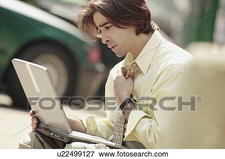 Man working on lap top computer View Large Photo Image Stock Photo - Man working on lap top computer. Fotosearch