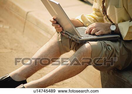 Stock Photo - Man works on computer. Fotosearch