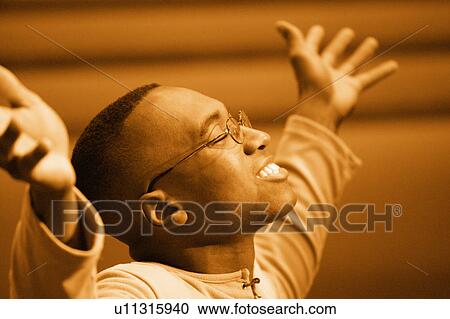 Stock Image - Man worshipping. Fotosearch