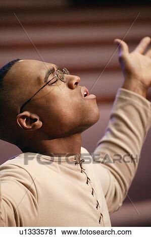 Stock Image - Man worshipping. Fotosearch