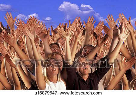 Stock Photo - Many hands raised in worship. Fotosearch