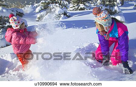 Mother and Daughter having a snowball fight View Large Photo Image Picture - Mother and Daughter having a snowball fight. Fotosearch