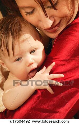 Mother holds baby in arms View Large Photo Image Stock Image - Mother holds baby in arms. Fotosearch