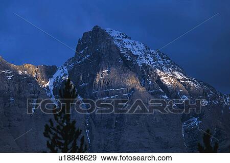 Stock Photo - Mountain against dark sky. Fotosearch
