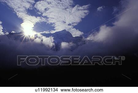 Picture - Mountain peak in the clouds. Fotosearch