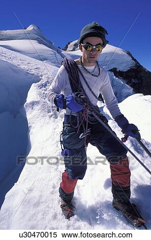 Mountaineer on a snowy slope View Large Photo Image Stock Photography - Mountaineer on a snowy slope. Fotosearch