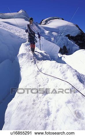 Stock Image - Mountaineer on snowy slope. Fotosearch