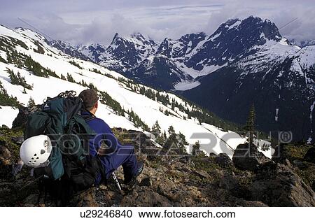 Stock Image - Mountaineer taking in the view. Fotosearch