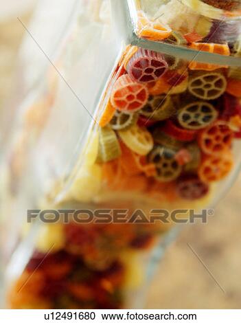Multi-colored pasta in a glass container View Large Photo Image Stock Image - Multi-colored pasta in a glass container. Fotosearch